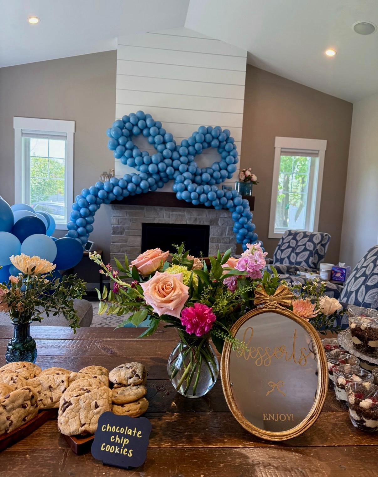 Dessert table with florals and custom balloon bow